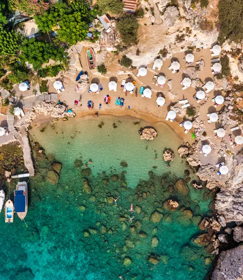 Aerial photo of beach goes and boats in the bay