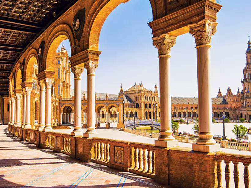 Walk the historical streets of Seville en route to the popular Plaza de Espana